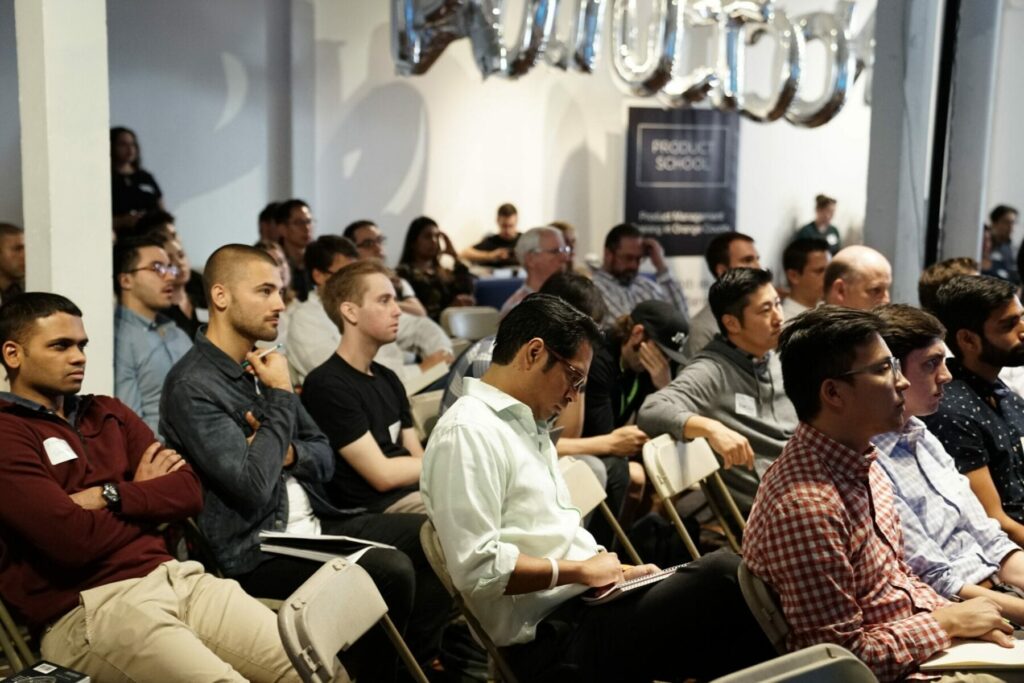 Group of people sitting in hall