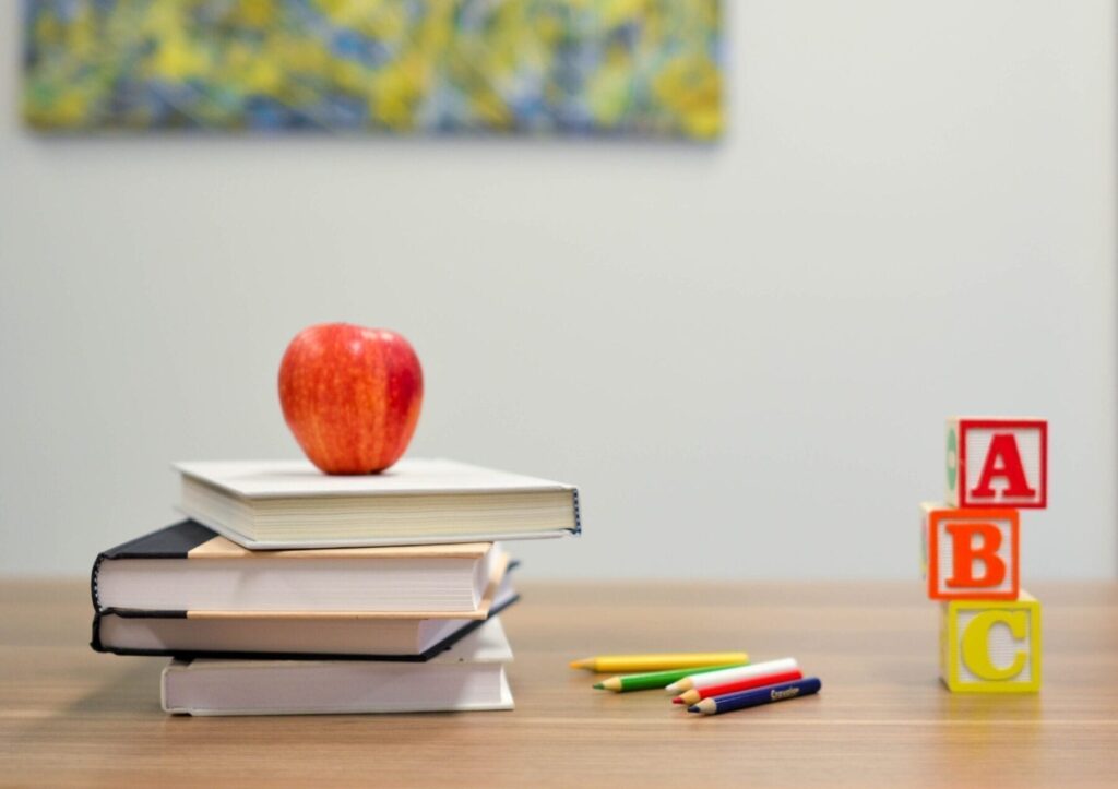 Desk with books and apple