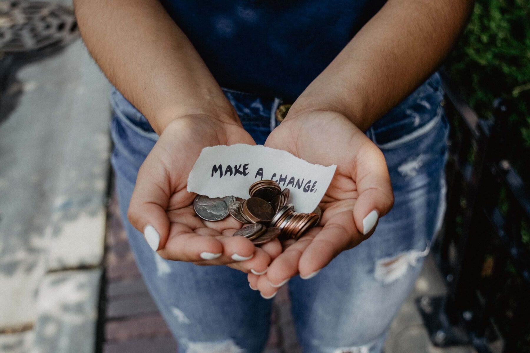 change in someone's hand with note