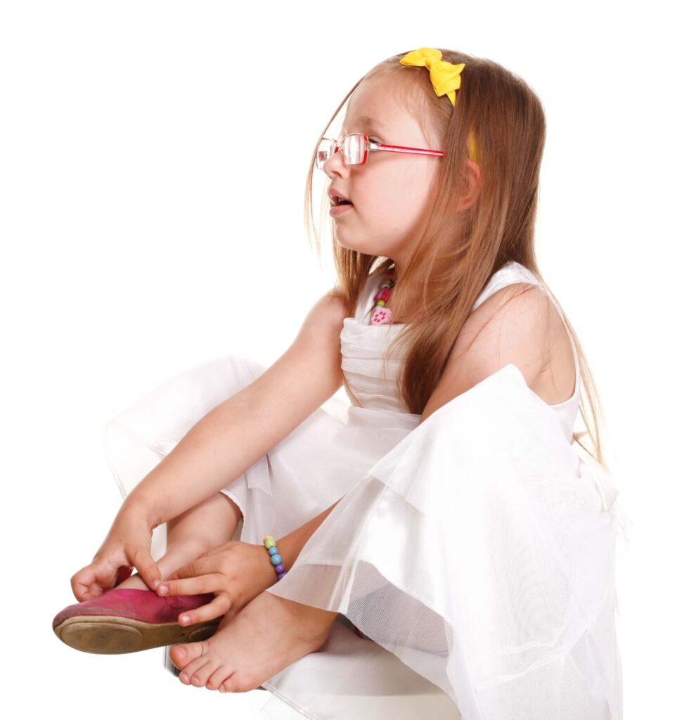 Autistic child putting on shoes