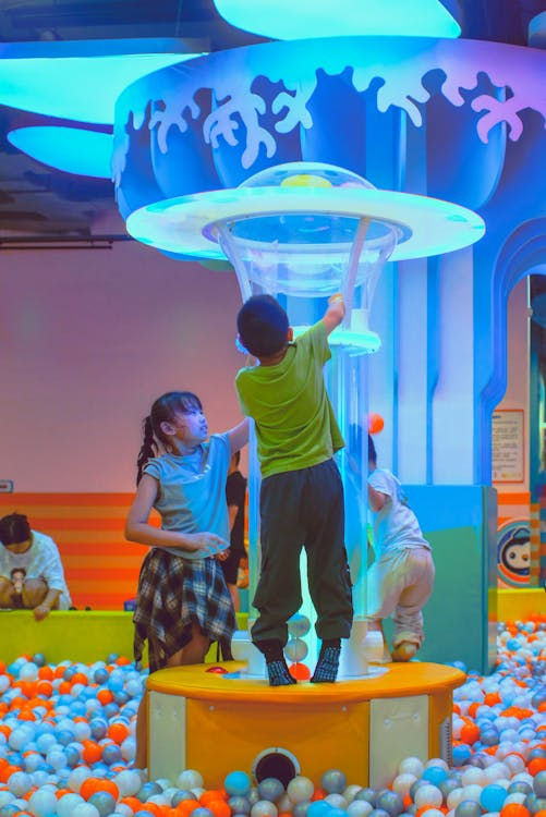 Children undergoing NET play-based therapy, engaging with colorful balls in a fun and interactive learning session.