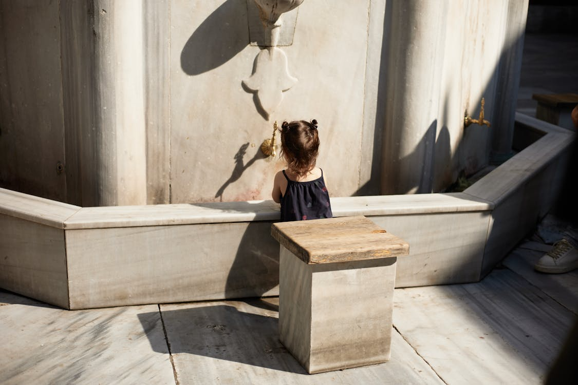 Child with autism quietly playing with soft afternoon light shadows on the floor, focused and engaged in a calming sensory experience.