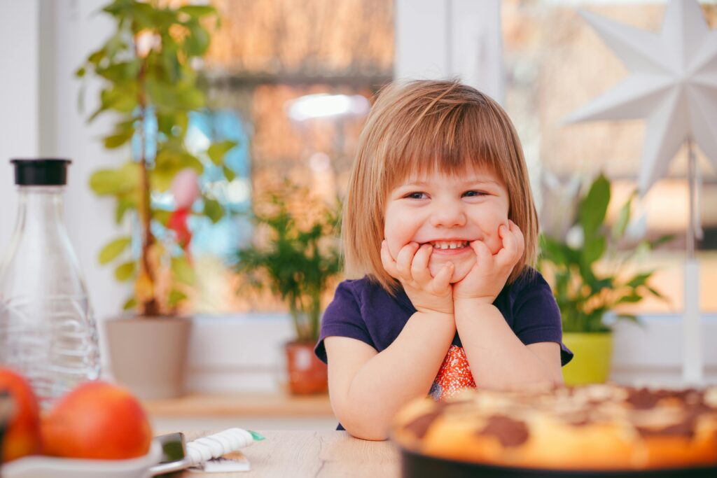 Smiling child mid-laughter in a bright therapy room, representing the positive impact of ABA New York on emotional and social growth.