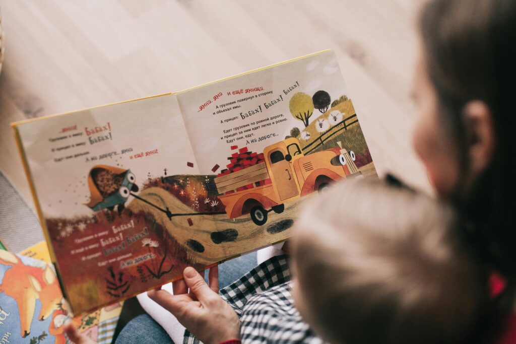 Parent reading a bedtime story to a child with autism, creating a calm and comforting nighttime routine.