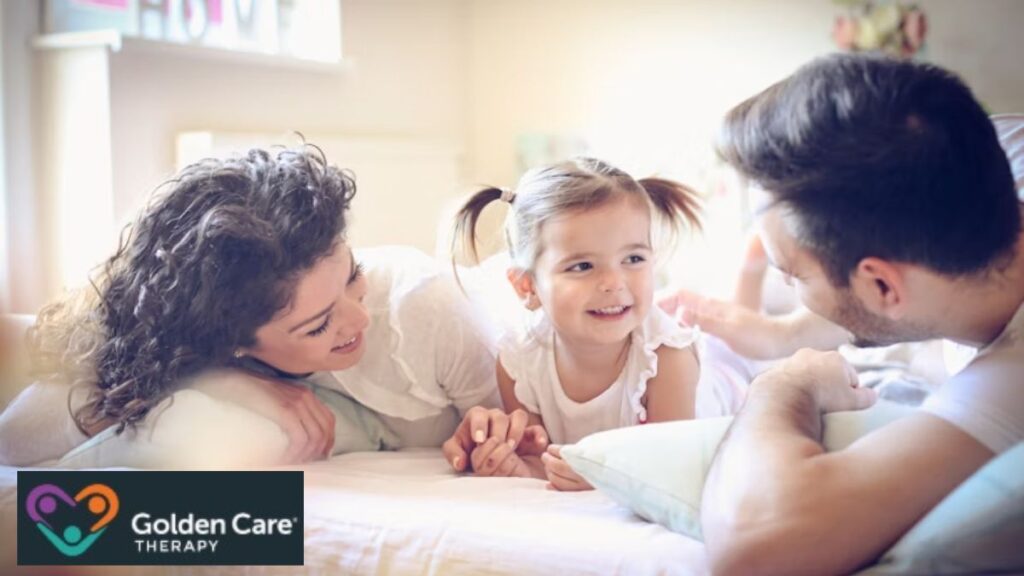 A family of three enjoys a joyful bonding moment in their living room on a sunny morning. Caption: Is autism hereditary?