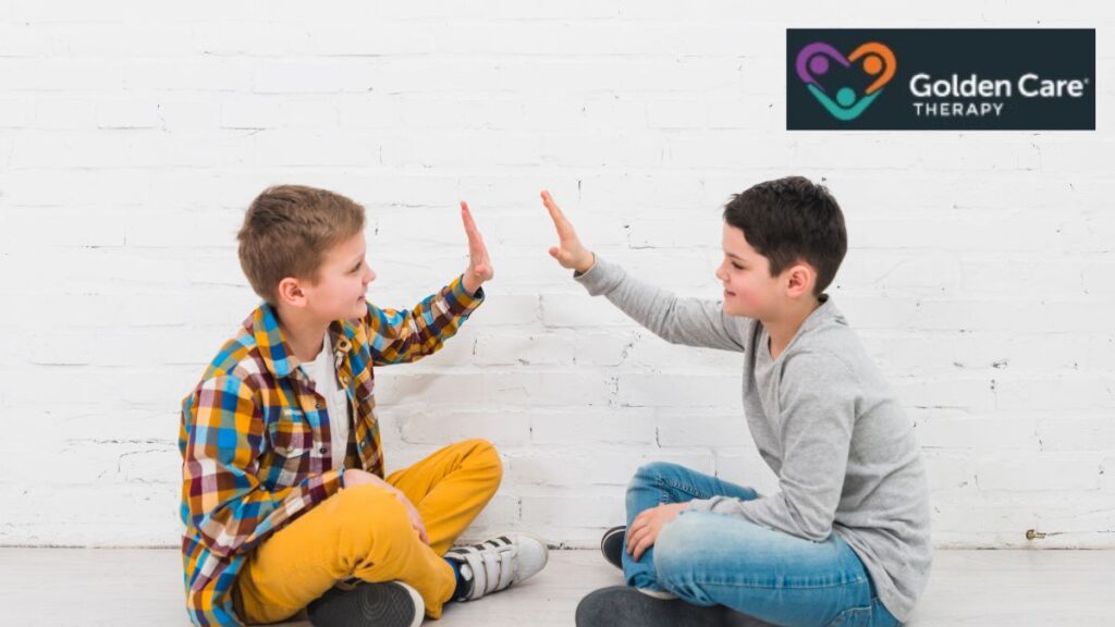 Two well-behaved boys, one with autism and one with ADHD, high-five each other, showing friendship and making their differences hard to notice.