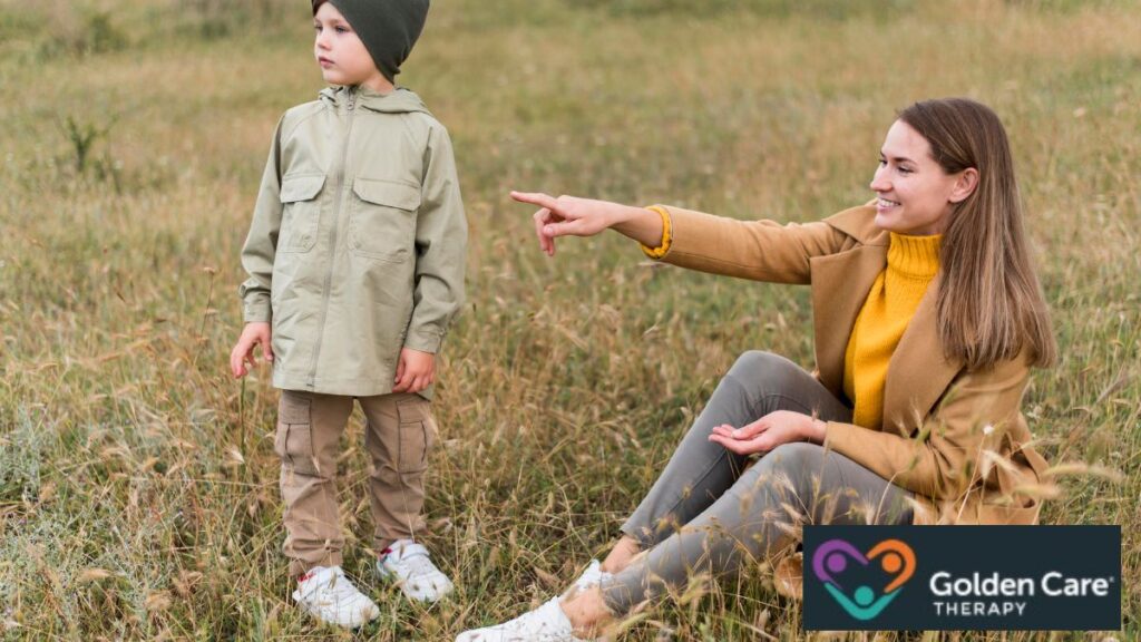 A child with autism follows the direction his mother or adult companion is pointing, demonstrating secure attachment through shared attention.