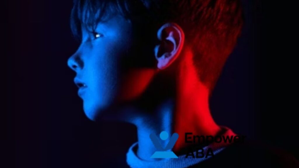 Side profile of a child illuminated by neon blue and red lights, symbolizing the contrast between ASD and Asperger’s.