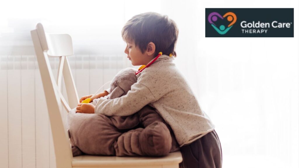 A young boy tightly hugs a teddy bear, showing emotional rigidity and refusal to let it go, illustrating a common behavior in autism.