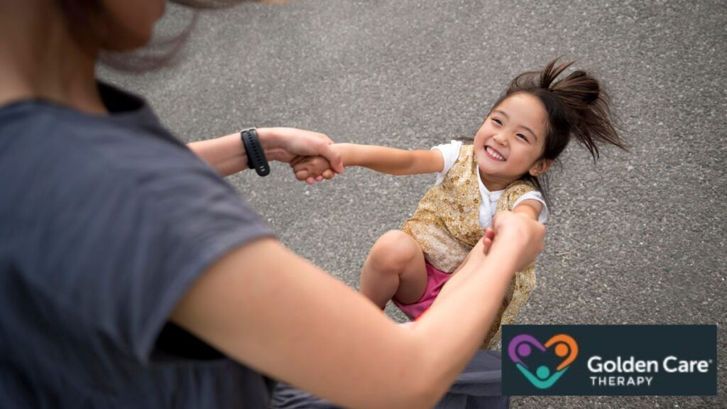 A young girl is gently swayed by her caregiver in the heart of a park, capturing a Monet-like moment of pure spontaneity and unbridled freedom.