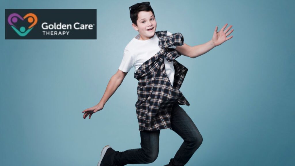 A young boy jumps and poses for the camera against a dark blue background, showing joy and energy.