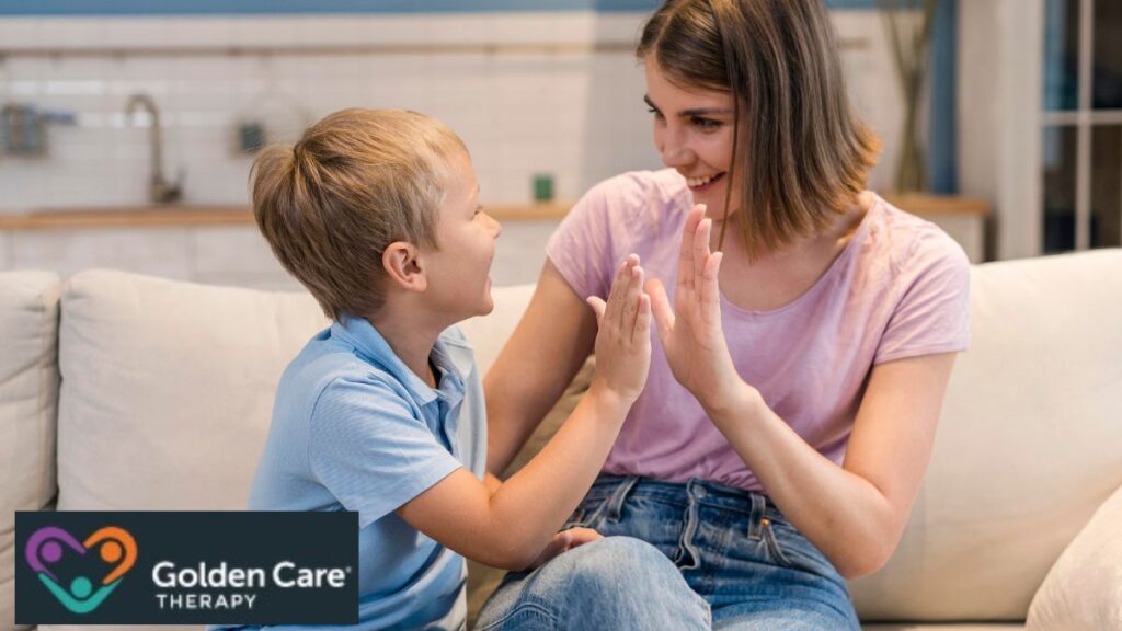 VB-MAPP assessment: A young boy shares a high-five with his therapist, celebrating a proud milestone in his learning journey.