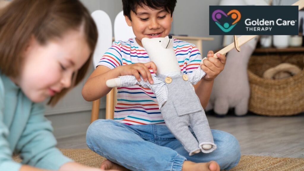 A young boy with autism plays with a teddy bear, using imaginative play to explore real-life social skills and healthy interactions.