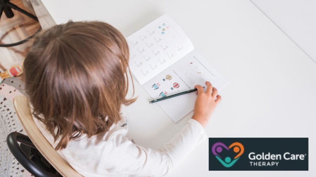 Top-down view of a child focused on completing a picture puzzle in a notepad, following a daily visual schedule.