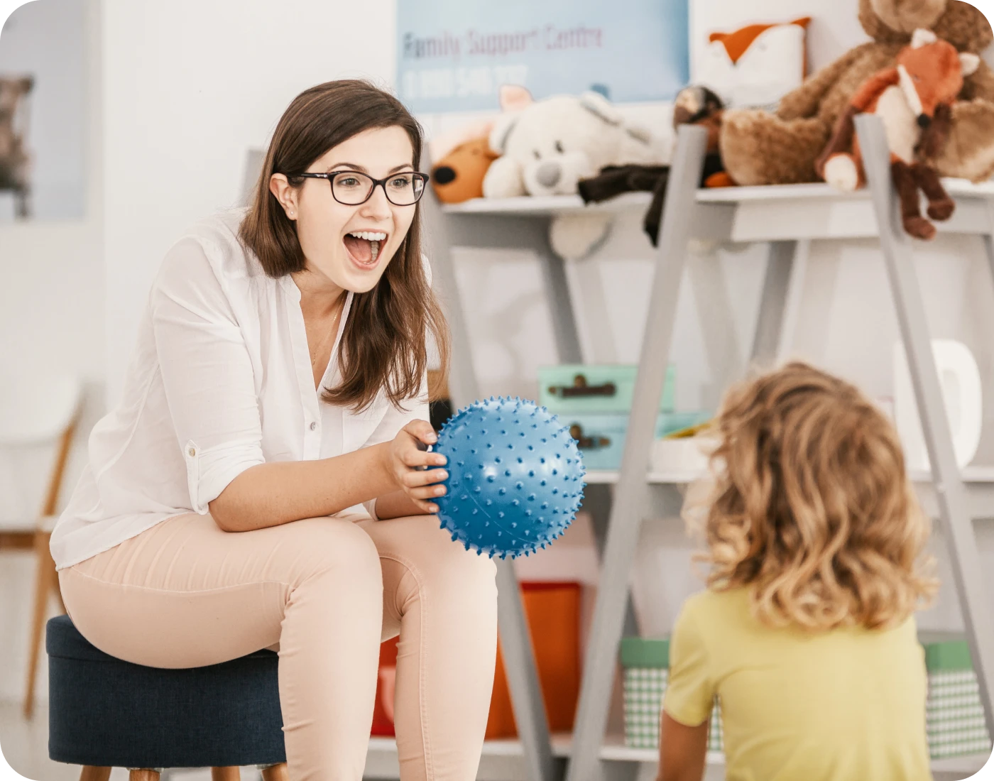 Therapist uses a sensory ball during a child-focused session